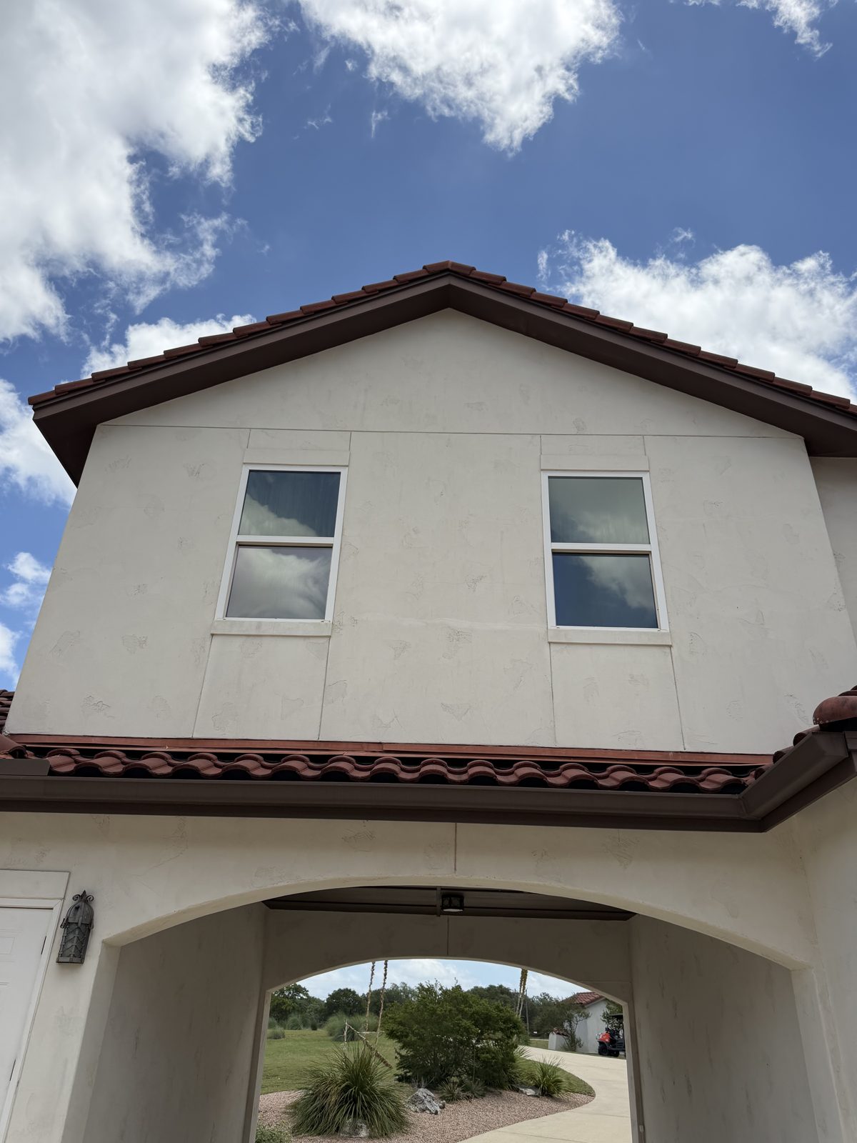 Same stucco home bright and clean after professional house soft wash