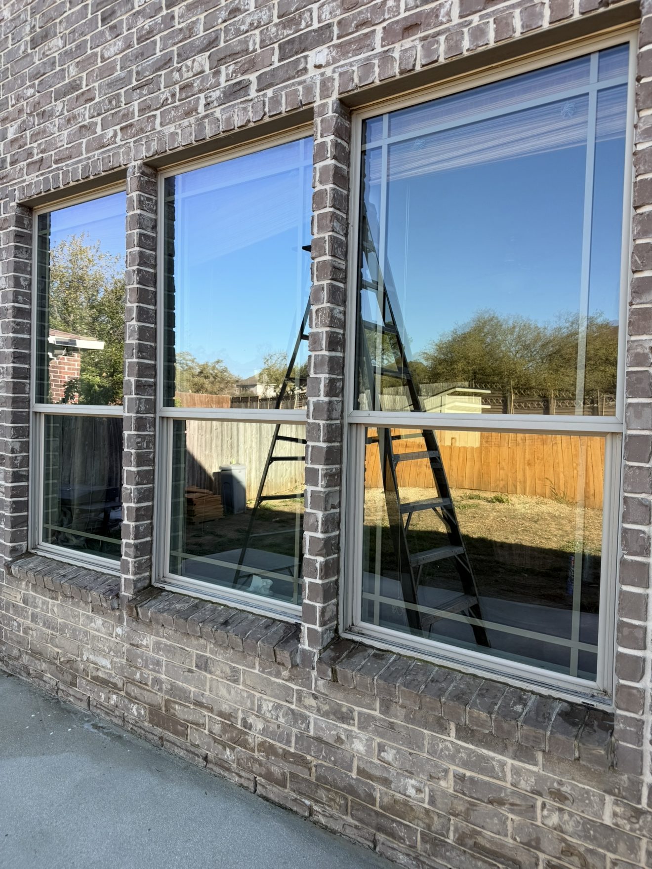 Crystal clear windows on a brick home after professional window and exterior cleaning