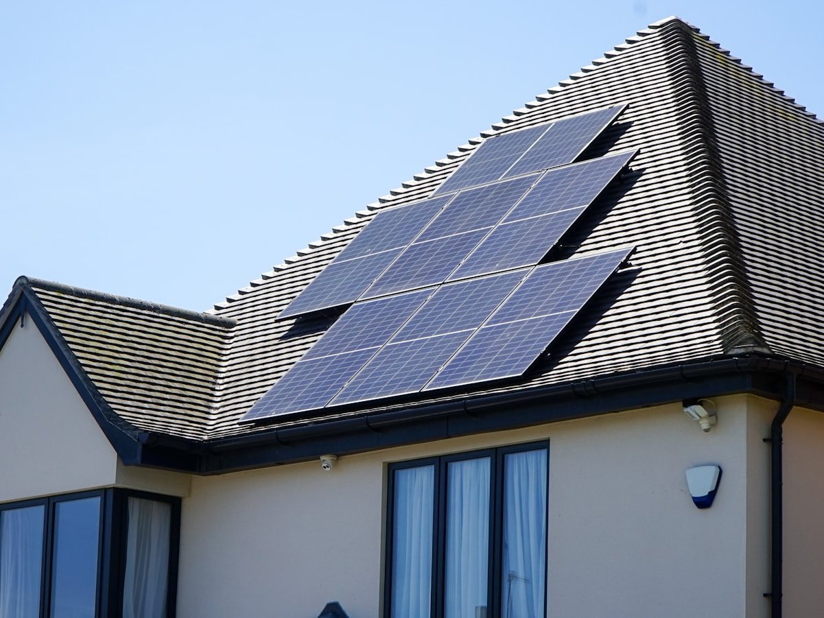 Technicians cleaning rooftop solar panels