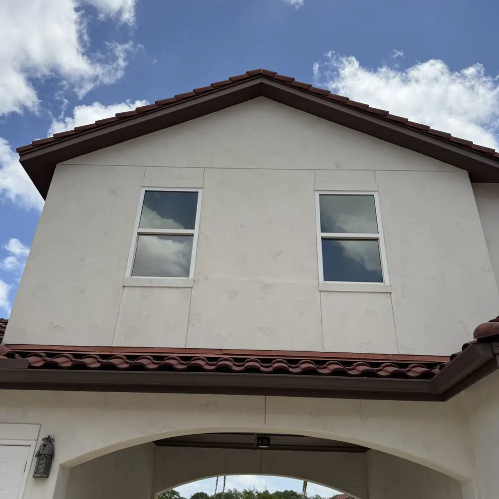Same stucco home bright and clean after professional house soft wash