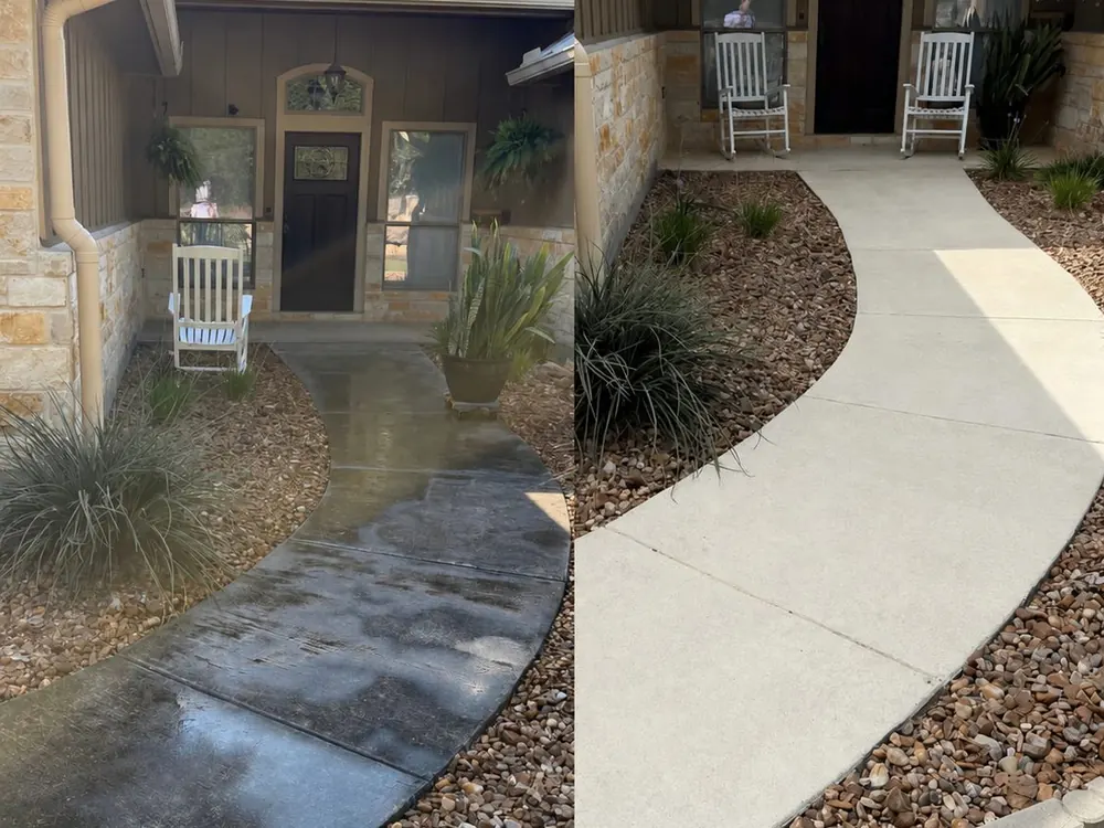 Before and after comparison of a concrete walkway cleaning at a metal-roof ranch home