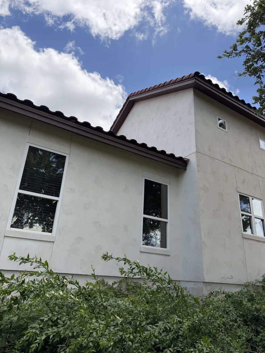 Two-story stucco home after professional house soft washing in the Texas Hill Country